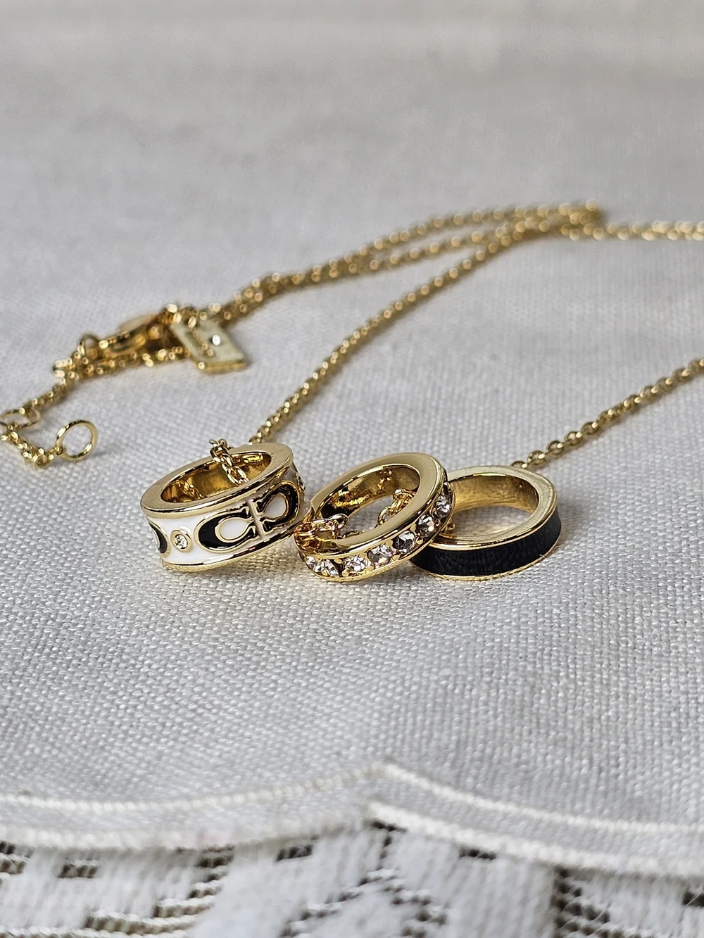 COACH Gold and Black Pendant Necklace with Crystal Accents
